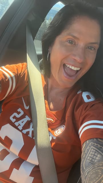 Mer smiling in an orange Texas shirt